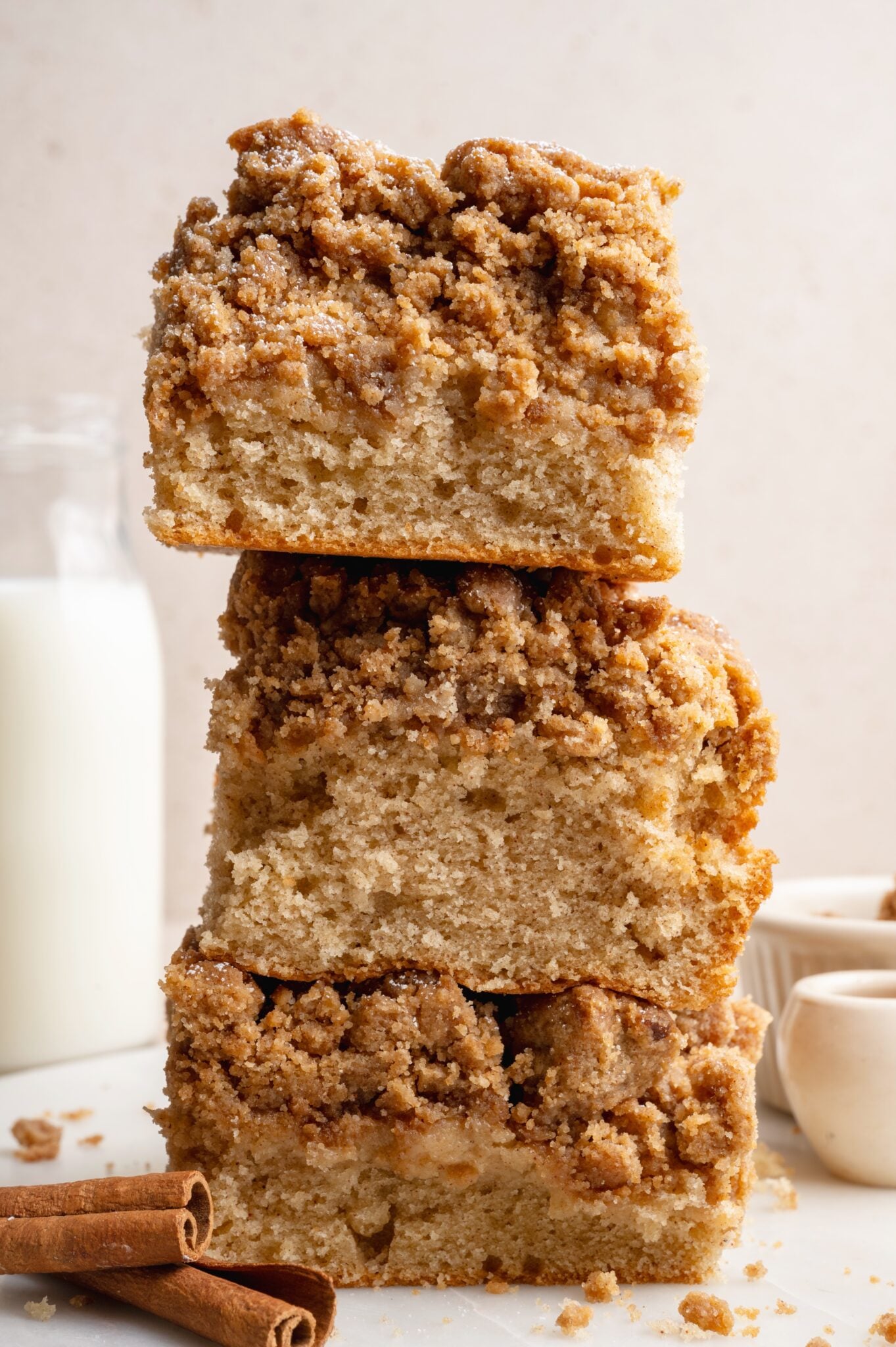 cinnamon crumb cake slices stacked on top of each other.