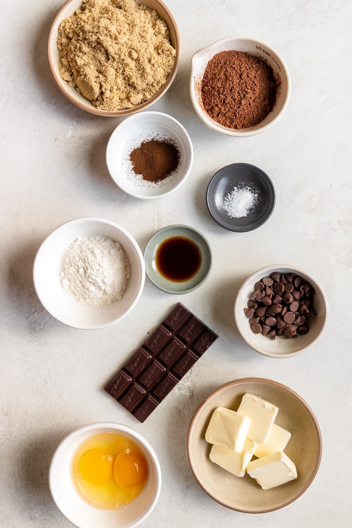 ingredients to make brownies in small white bowls. 