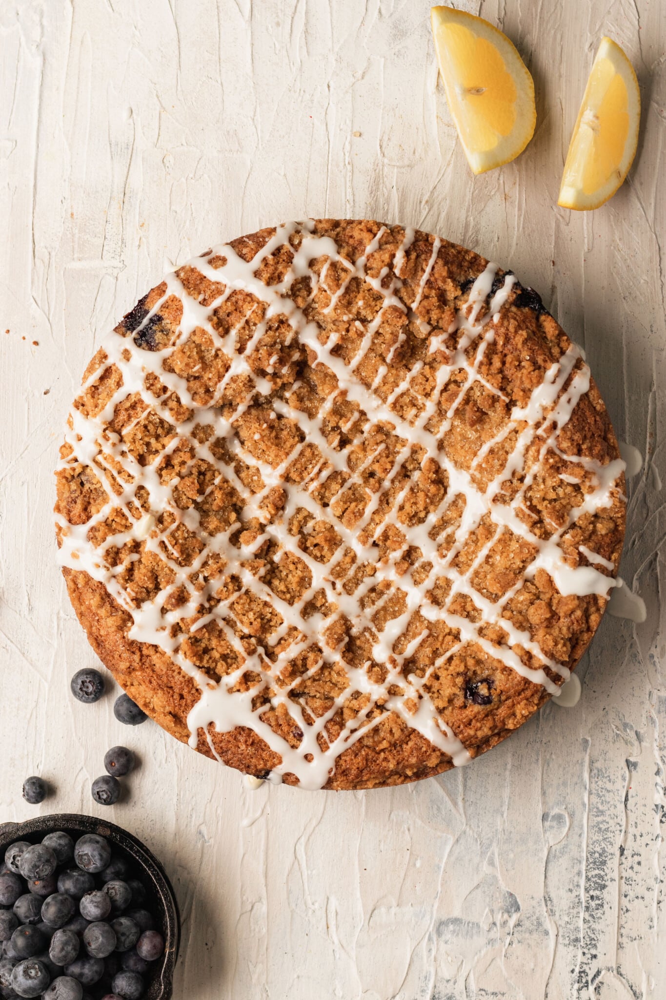 blueberry coffee cake with glaze on top.