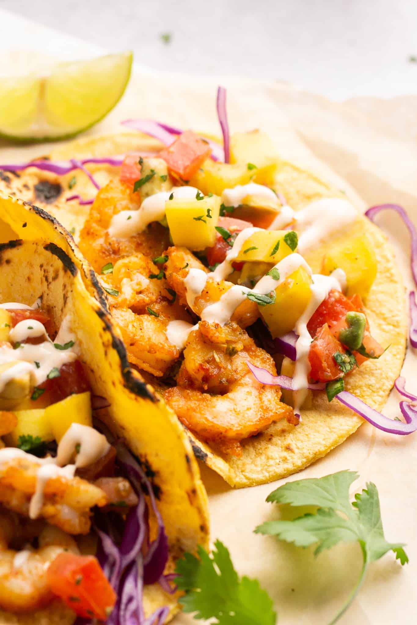a shrimp taco with mango salsa on top. 