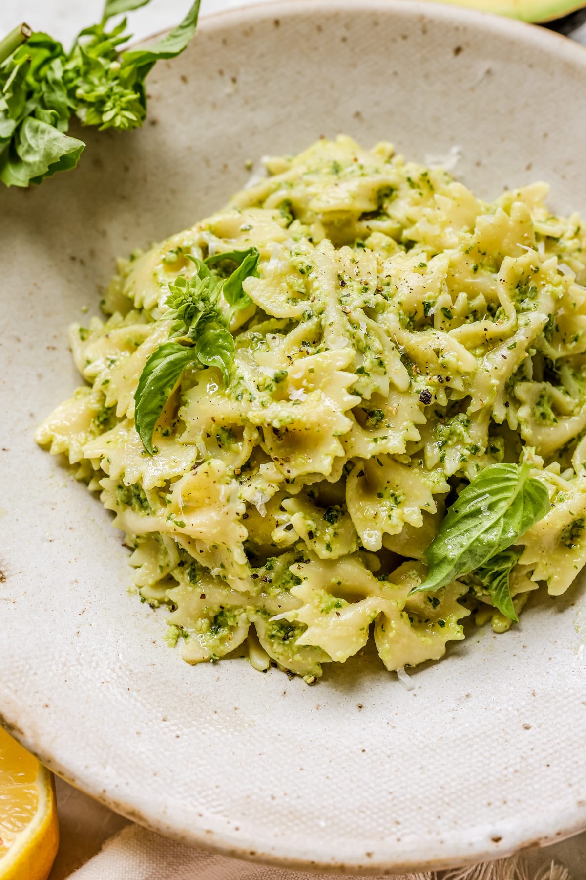 pesto in a bowl garnished with basil and black pepper. 