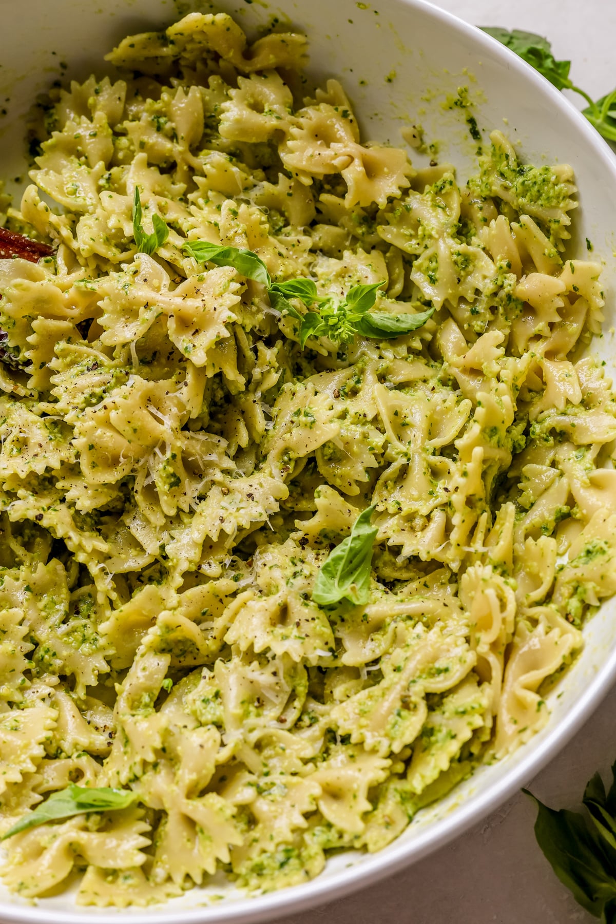 pesto pasta in a large white bowl.