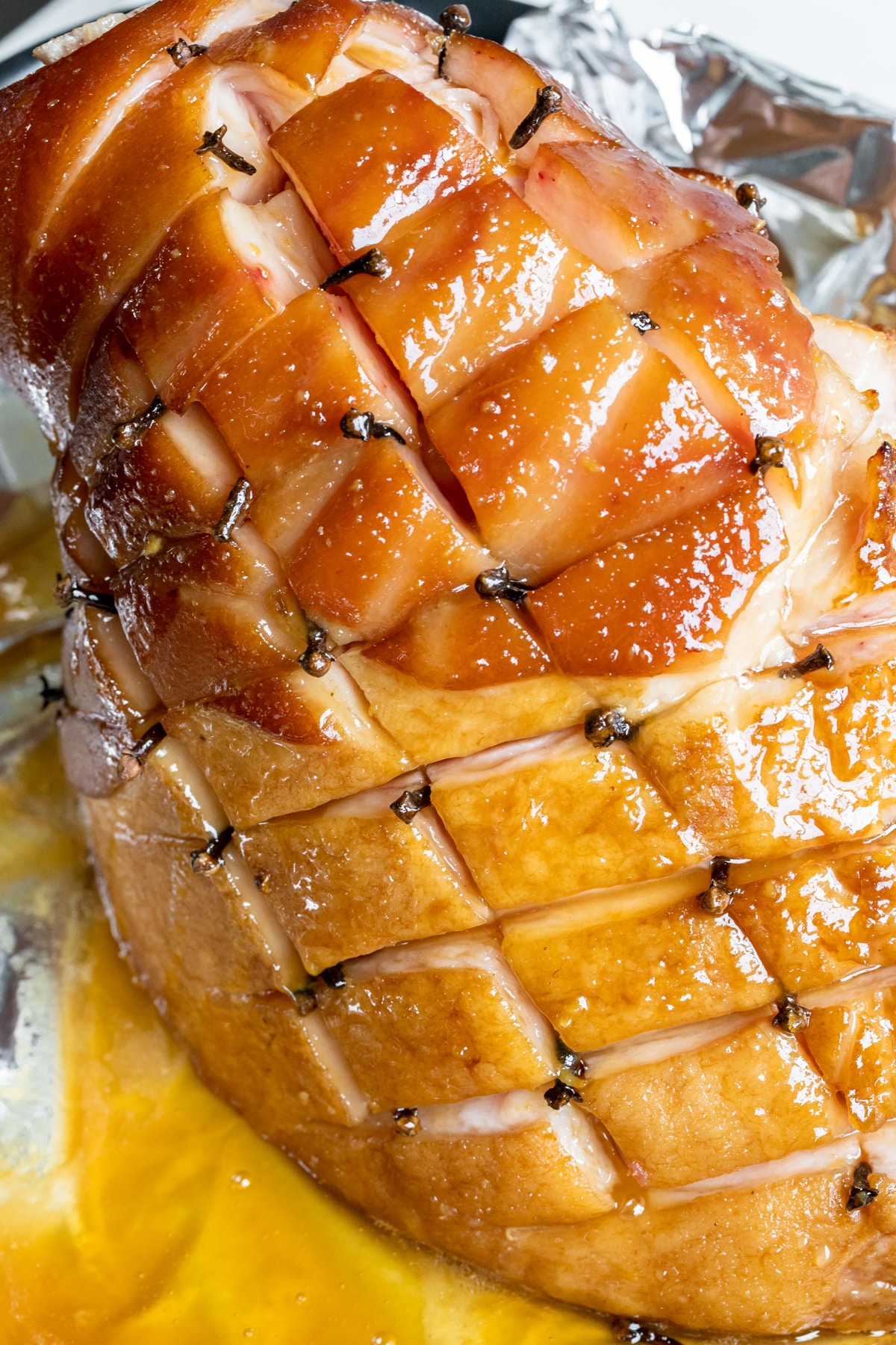 a ham with honey glaze on top and whole cloves in it. 