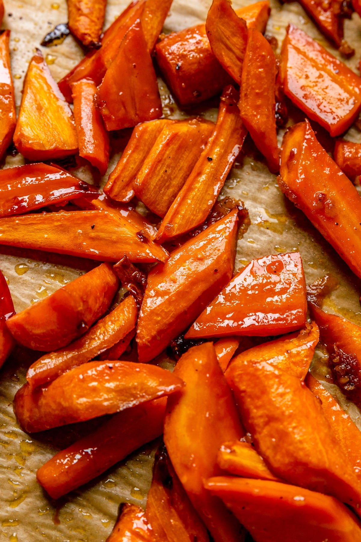 roasted carrots with a honey glaze on a baking sheet. 