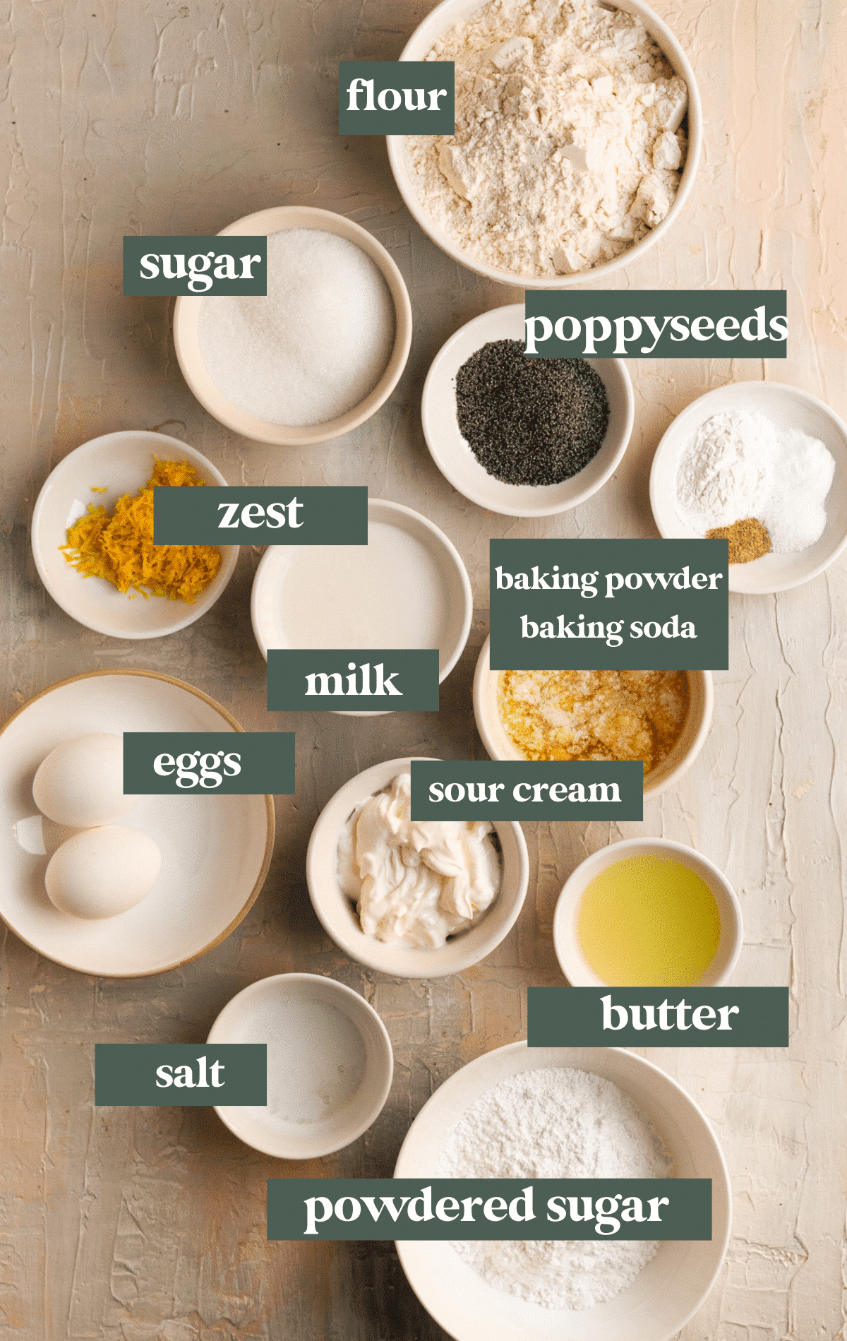 ingredients in small bowls needed to make lemon poppyseed muffins. 