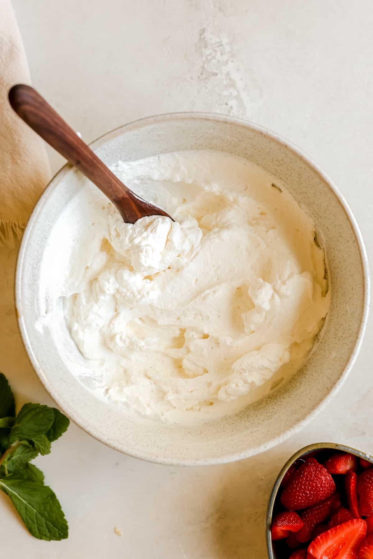 homemade whipped cream in a white bowl.