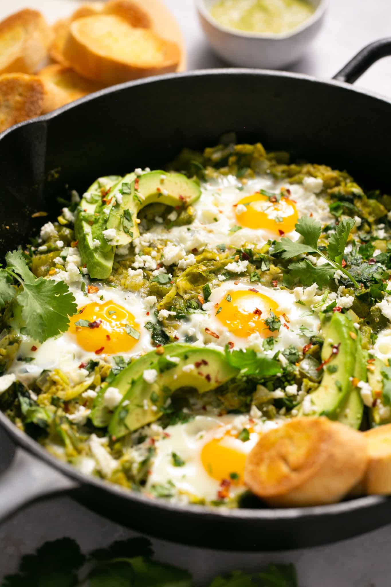 eggs and veggies in a cast iron pan.
