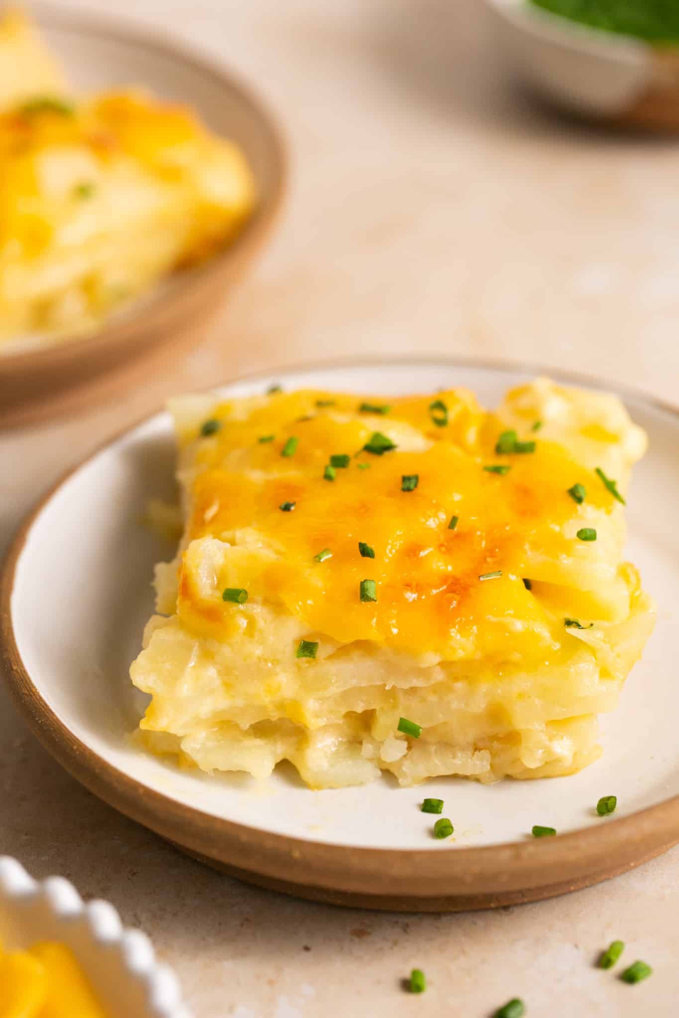 cheesy potatoes on a white plate. 
