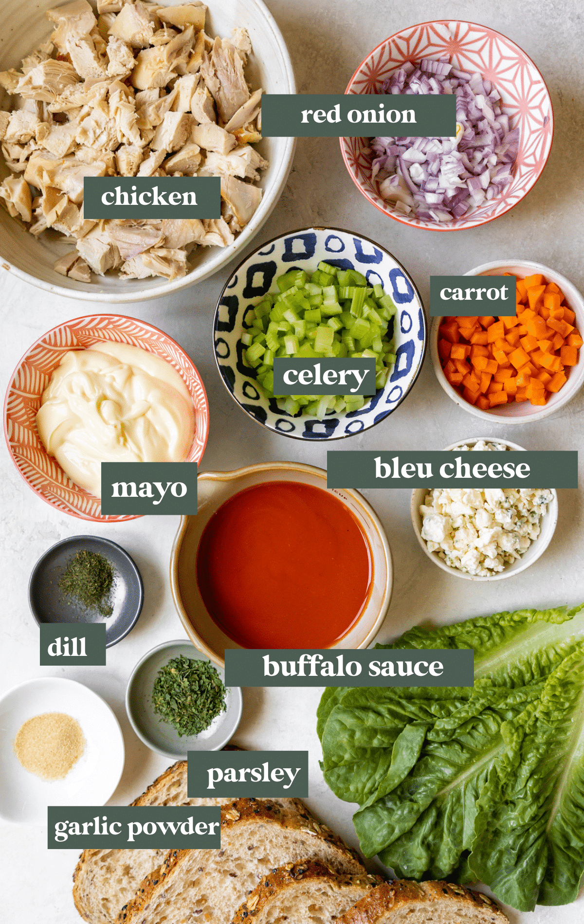 ingredients in small glass bowls needed to make a chicken salad. 
