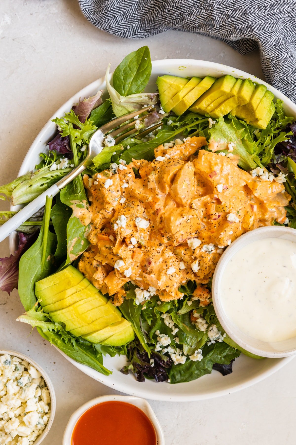 chicken salad on a mix of greens and garnished with bleu cheese and avocado. 