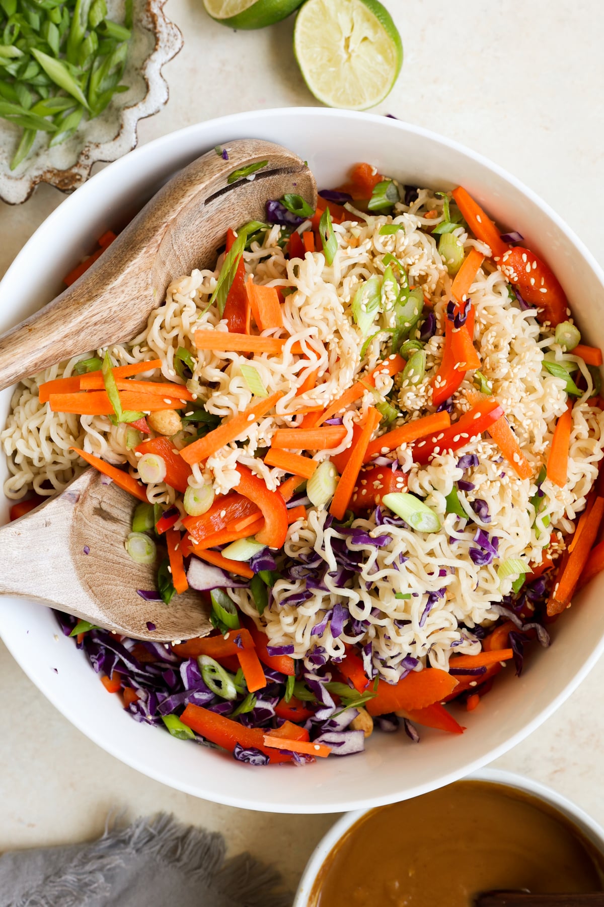 noodle salad in a white bowl with sesame seeds on top. 