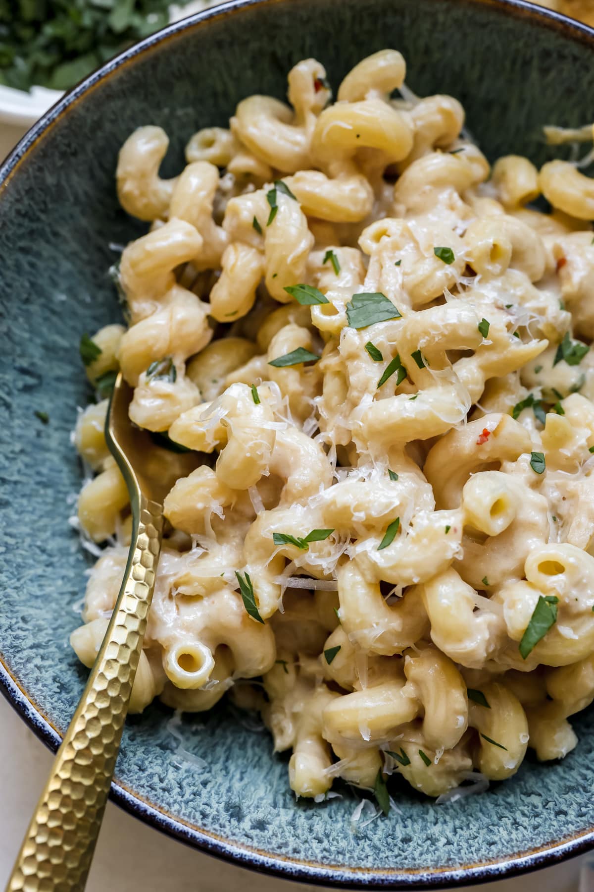 up close image of pasta in a blue bowl.