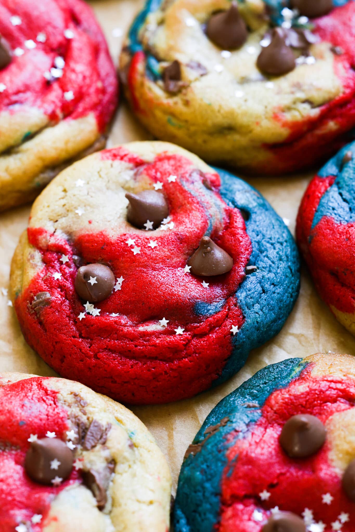 a festive cookie made with red and blue food coloring decorated with silver glitter stars. 