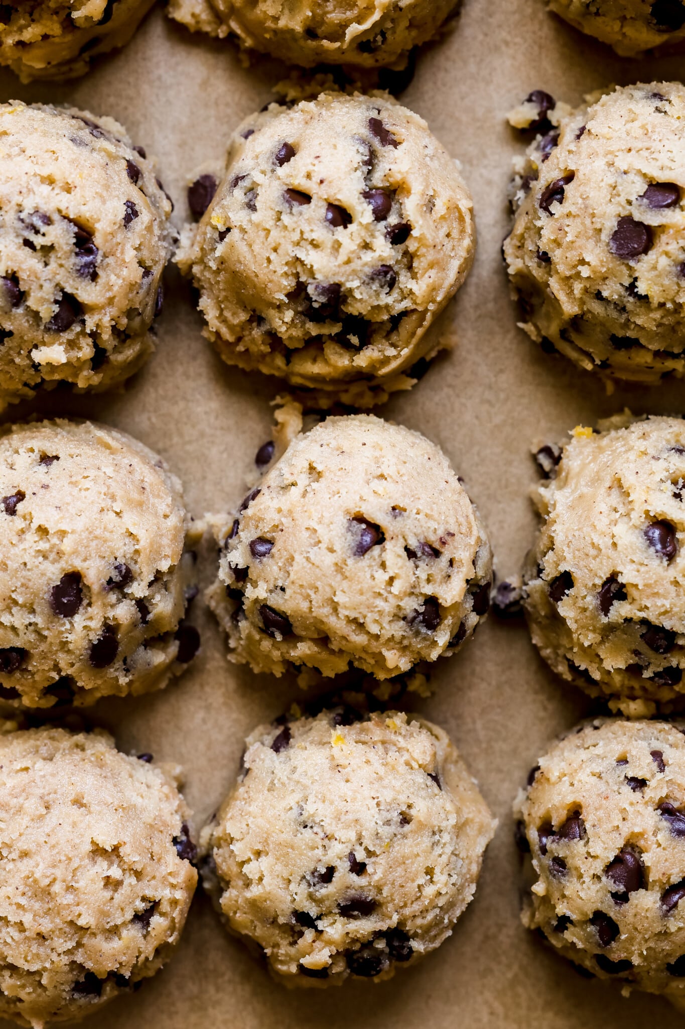 cookie dough balls on parchment paper.