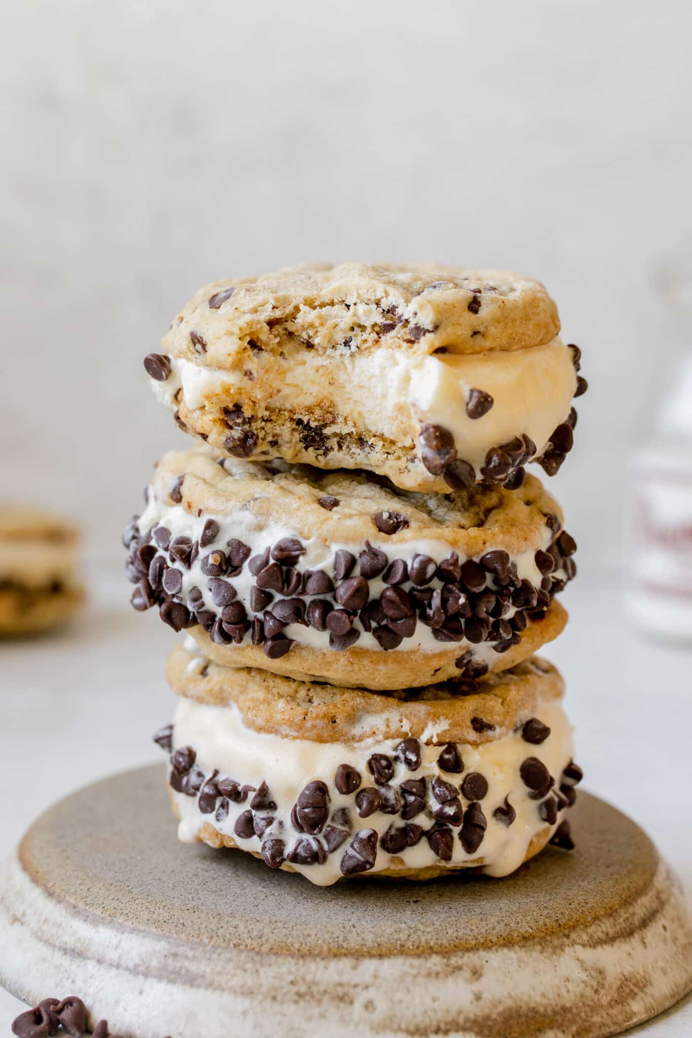 a bite taken out of a cookie ice cream sandwich. 