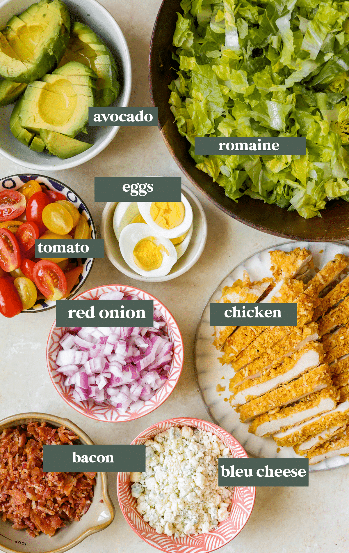 ingredients to make a cobb salad in small glass bowls. 