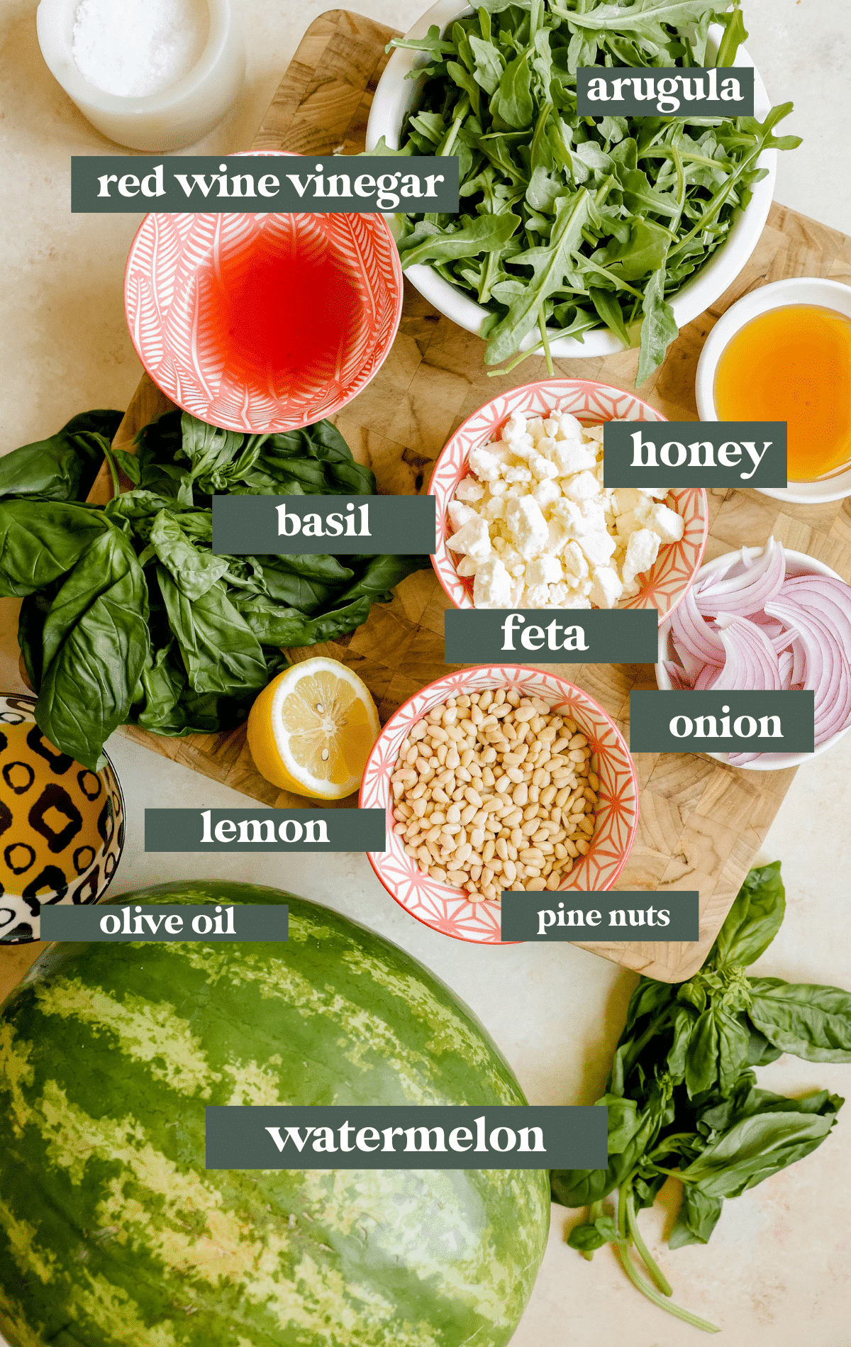 ingredients on a cutting board to make a watermelon salad.