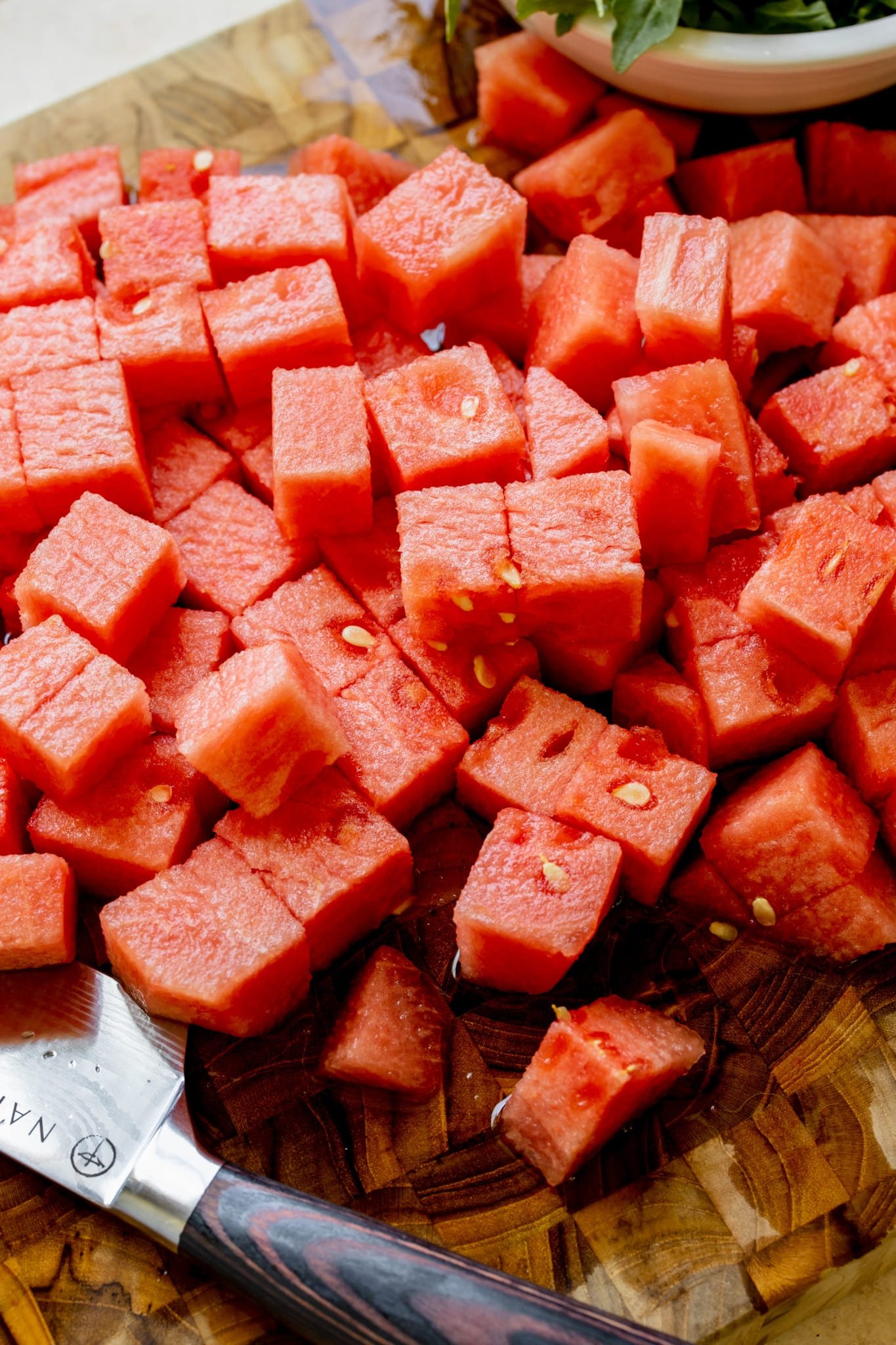 cubed watermelon on a cutting board.