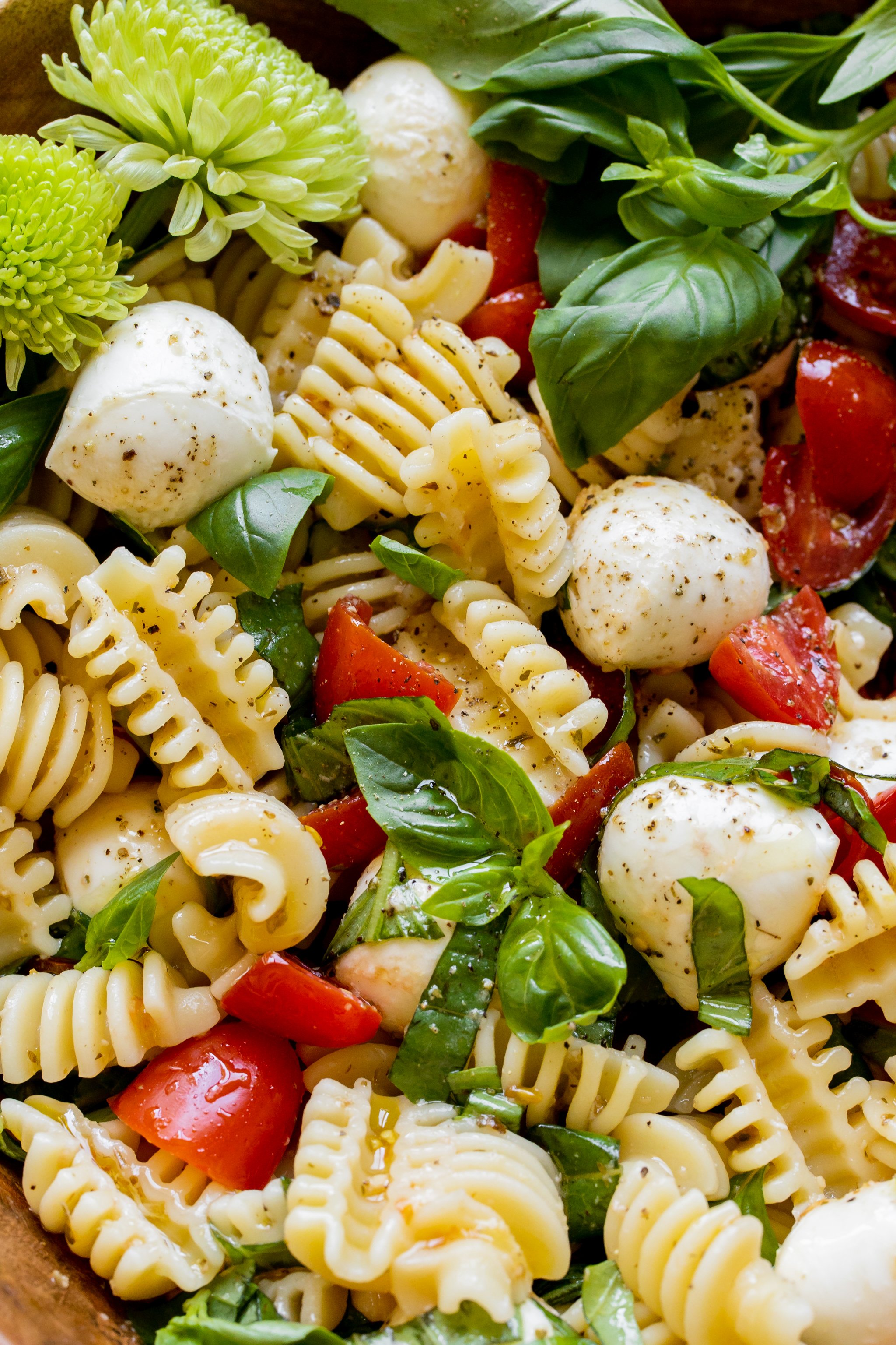 an up close image of caprese pasta salad. 