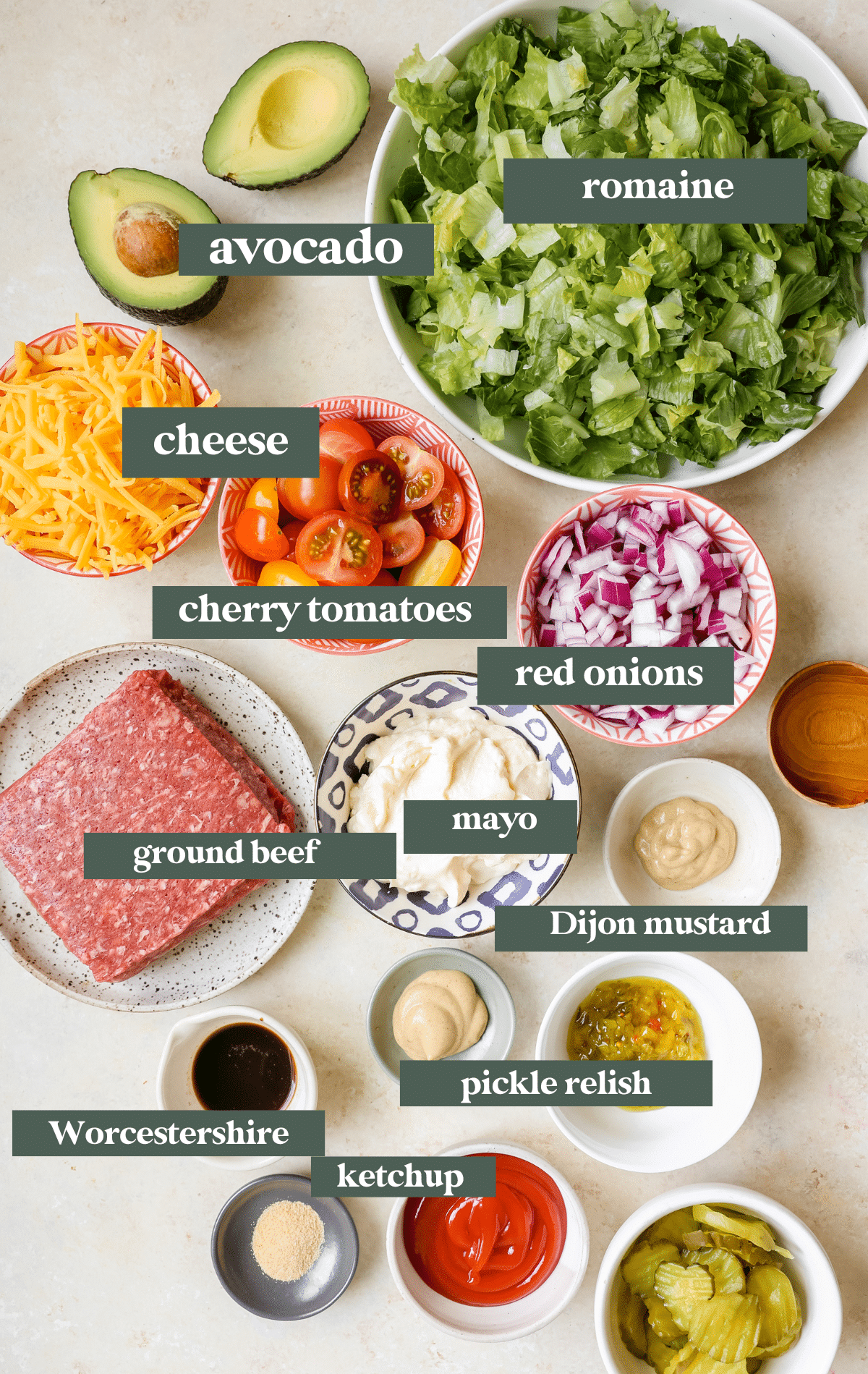 ingredients to make burger salad in small glass bowls. 