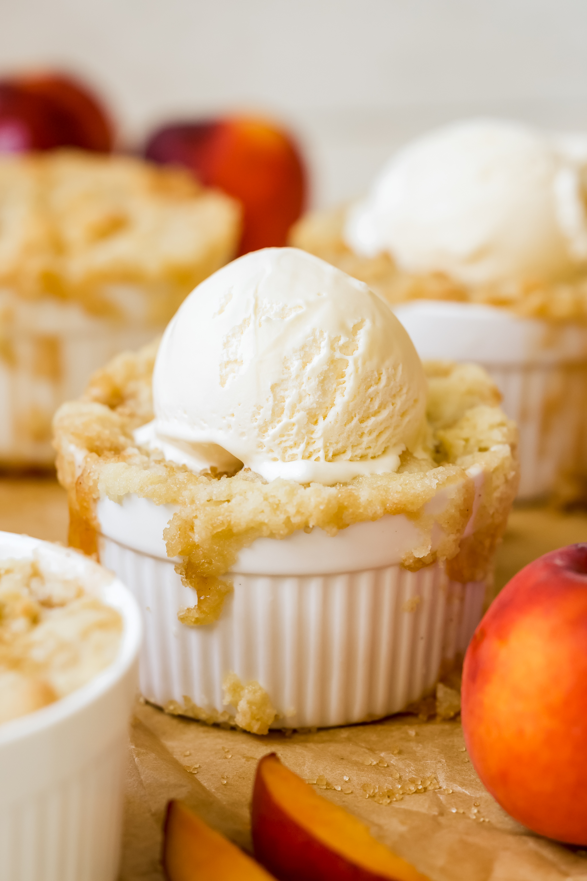 cobbler in a white ramekin with vanilla ice cream on top. 