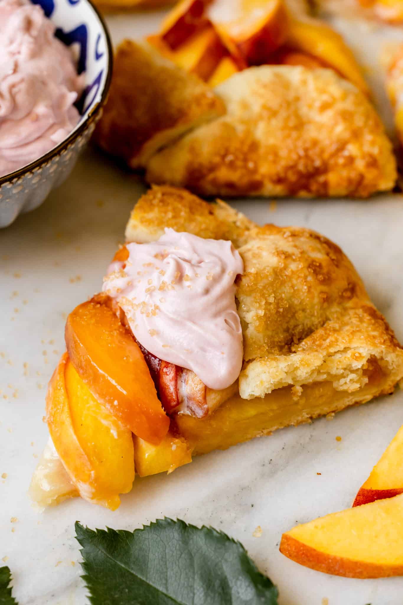 a galette made with peaches topped with a raspberry whipped cream. 