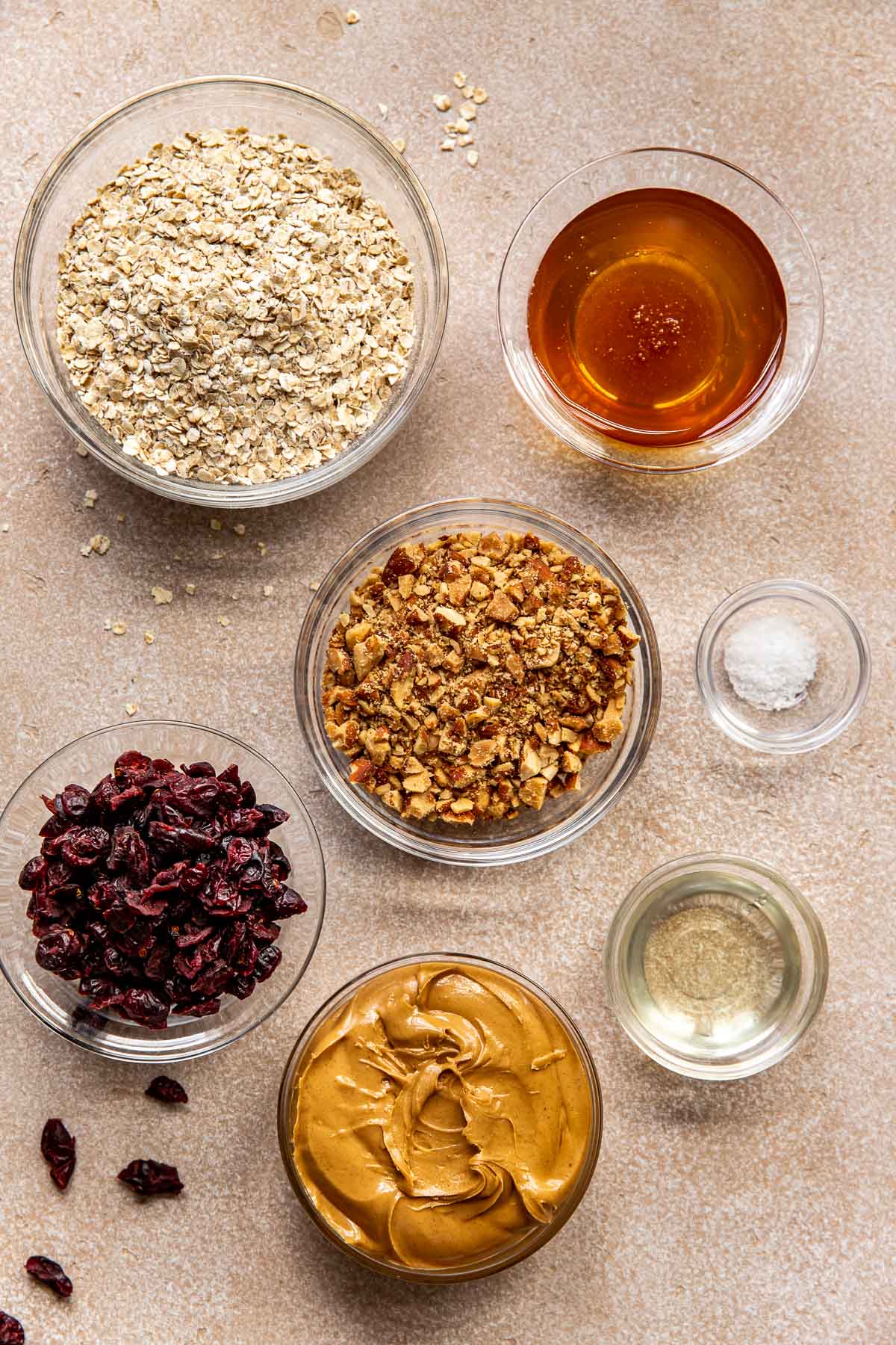 ingredients needed to make energy bars in small glass bowls.