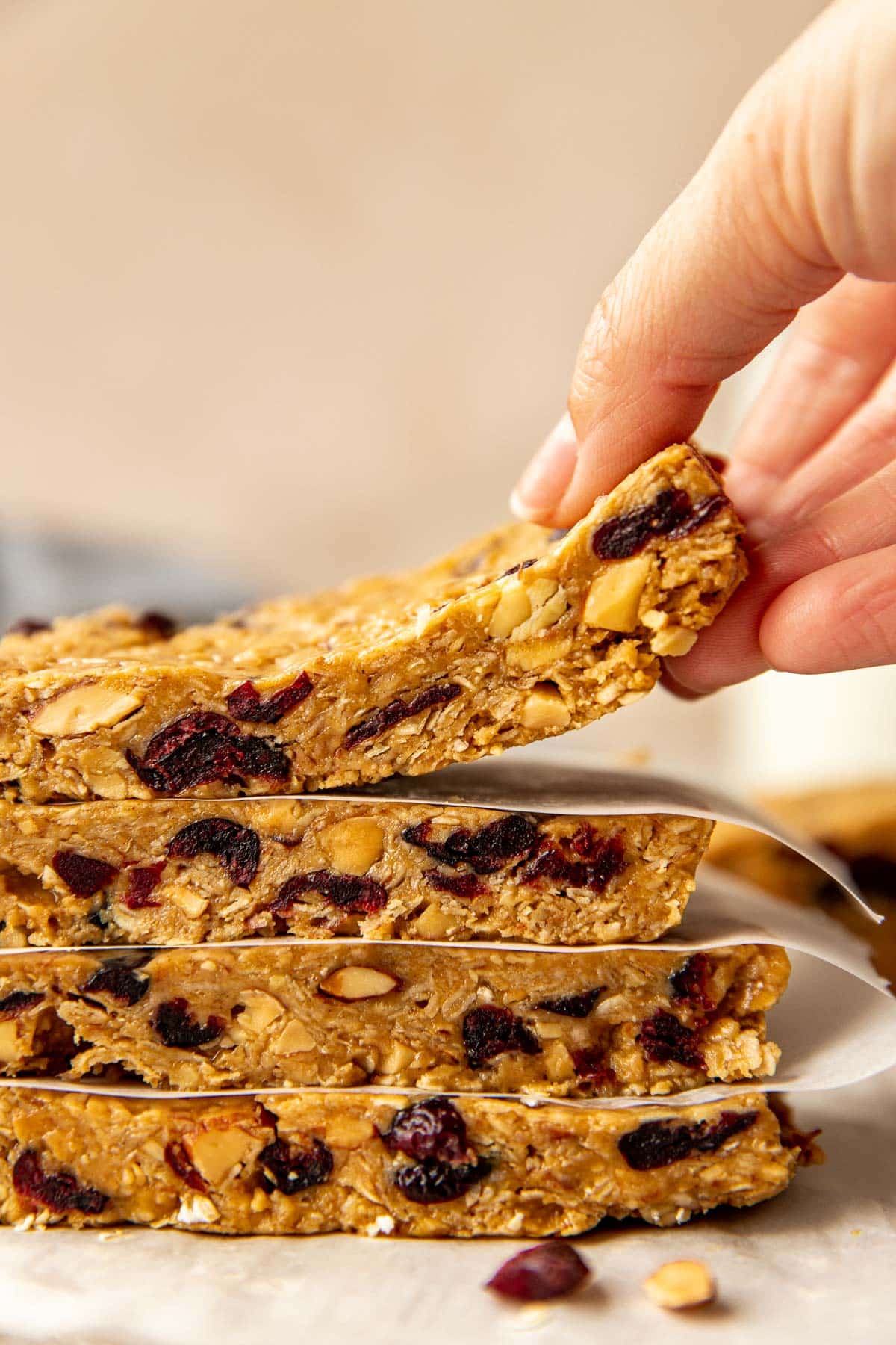 a woman's hand picking up an energy bar.