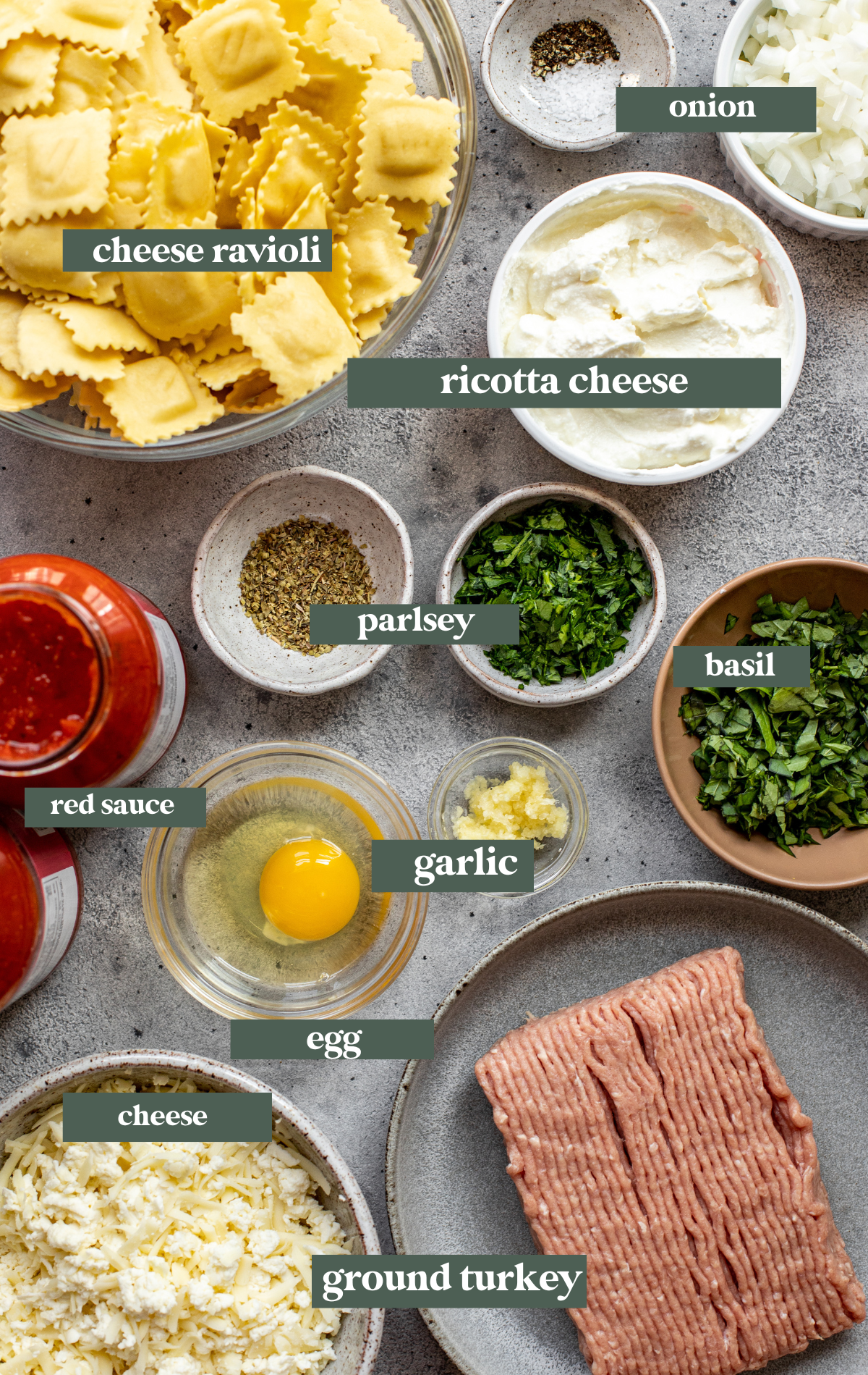 ingredients needed to make lasagna in small glass dishes. 