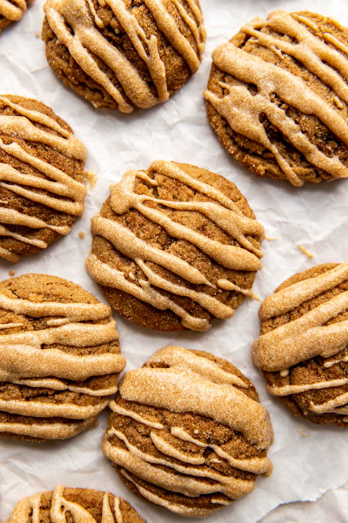 glazed apple butter cookies on white parchment paper. 