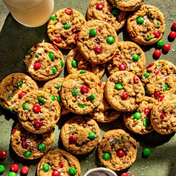 large amount of christmas monster cookies with red and green m&ms