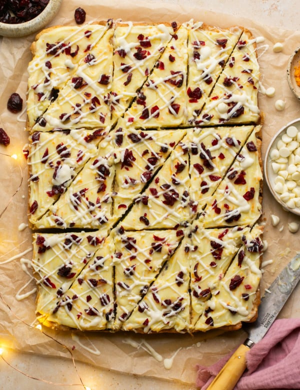sheet of cranberry bliss bars with triangleur cuts made