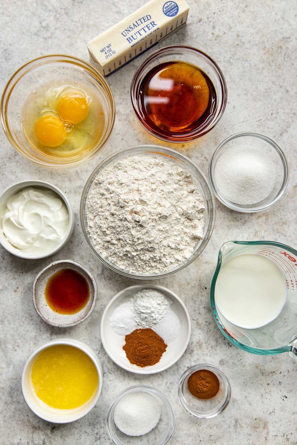 ingredients needed to make muffins in glass bowls. 