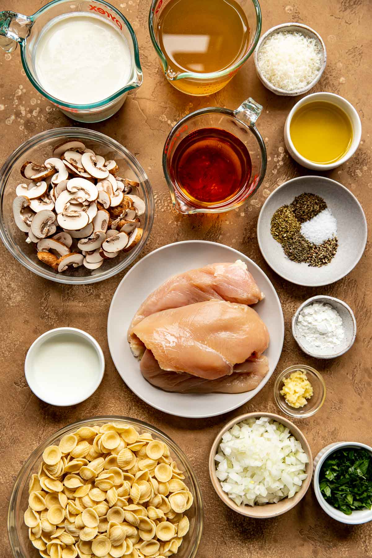 ingredients to make chicken marsala in small glass dishes.