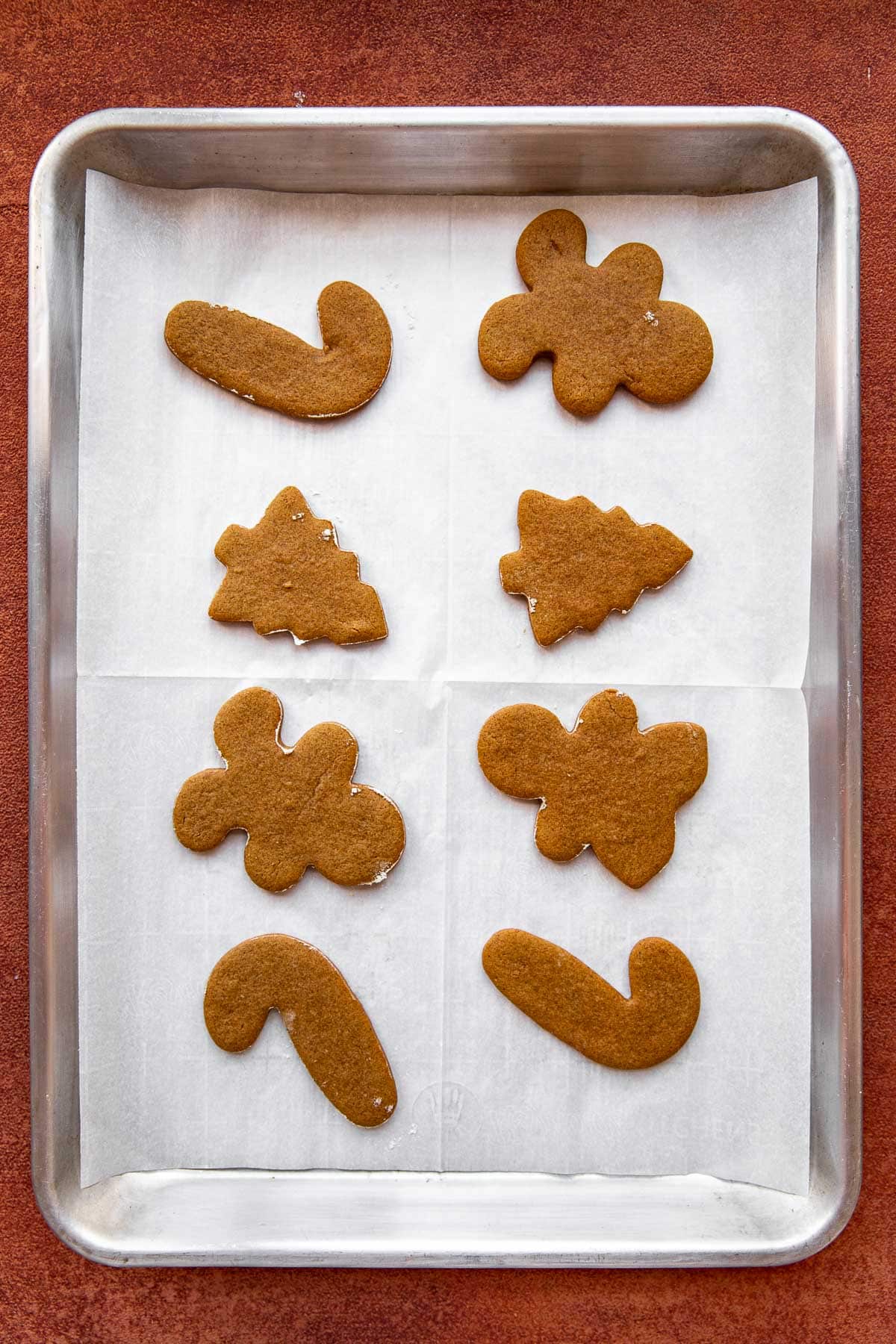 gingerbread man cookies on a cookie sheet lined with parchment paper. 