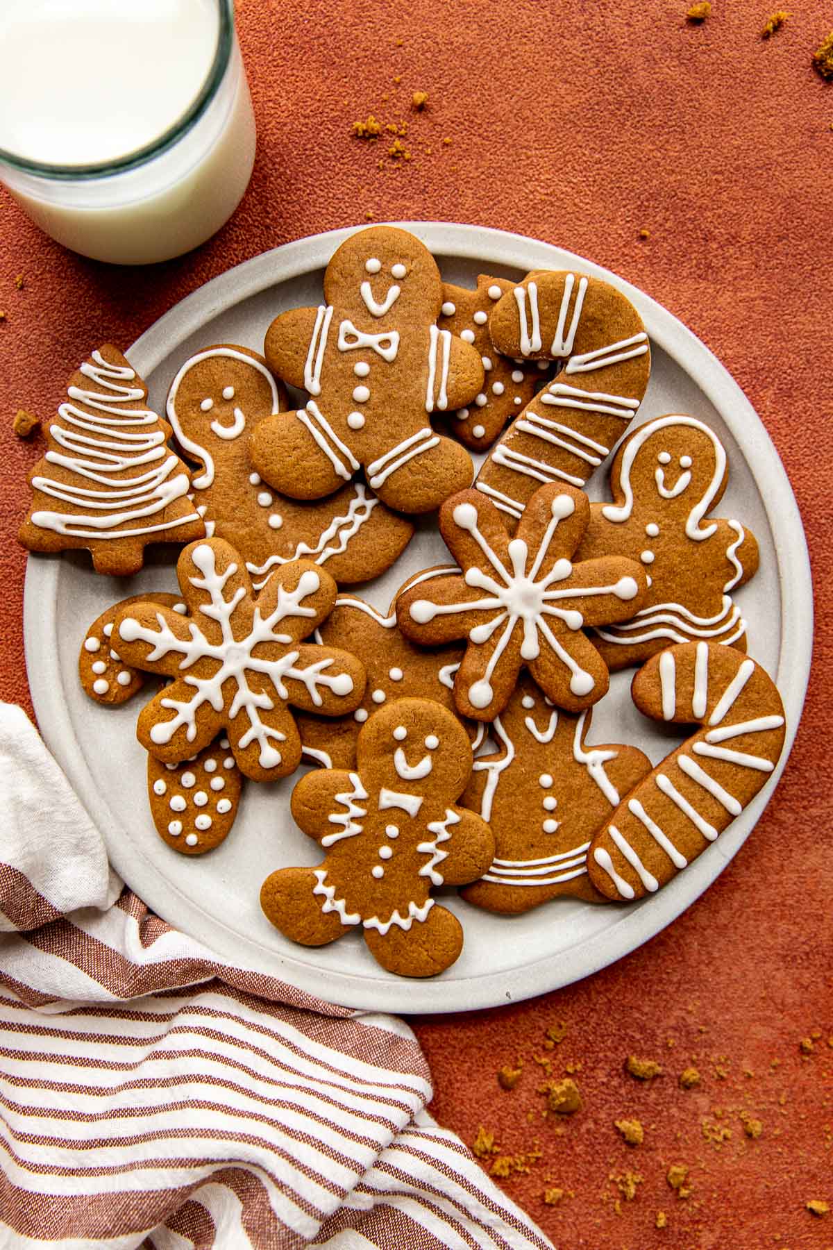 gingerbread men cookies on a white plate decorated with decorative frosting. 