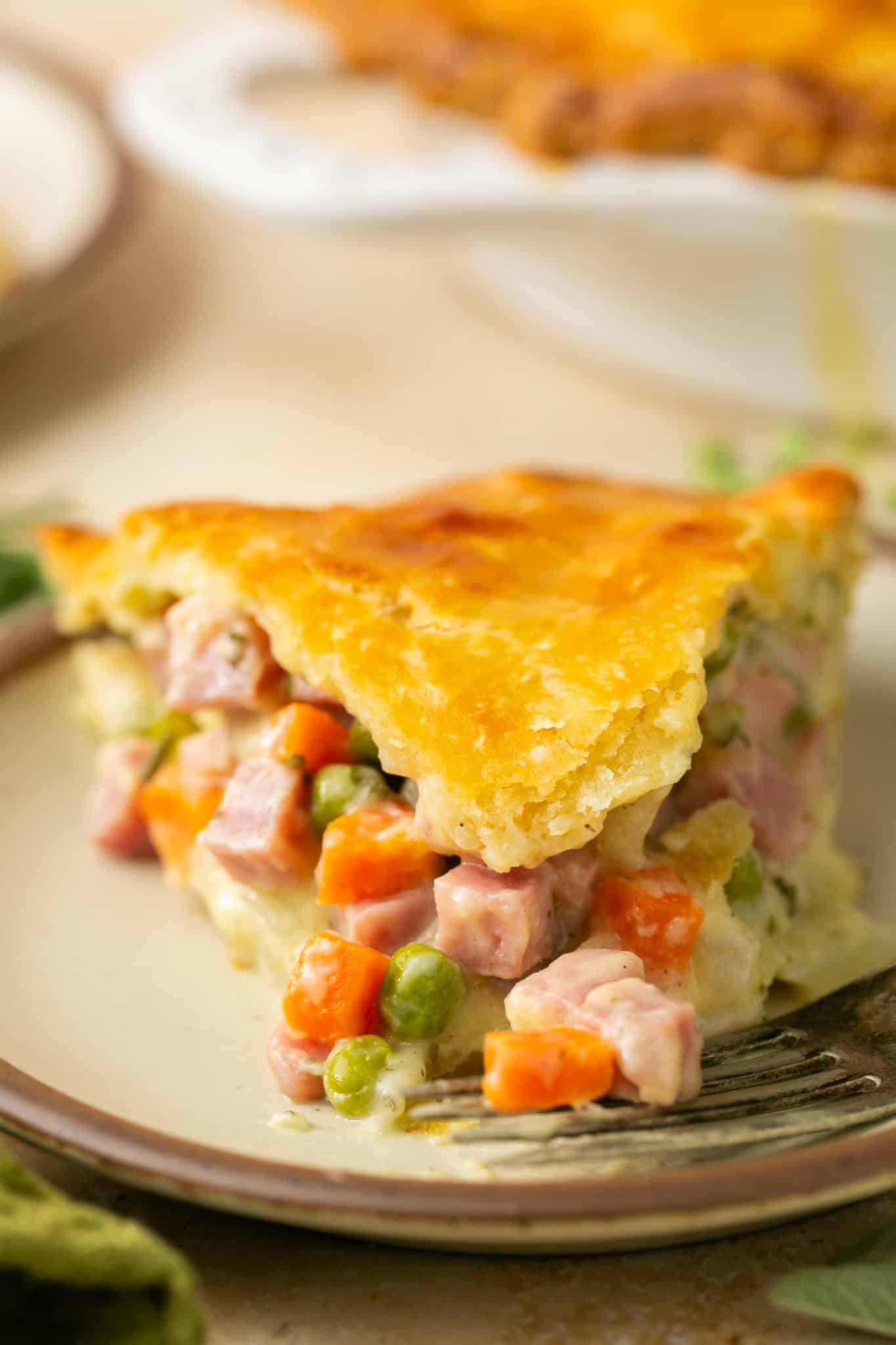 an up close image of pot pie made with vegetables and ham. 