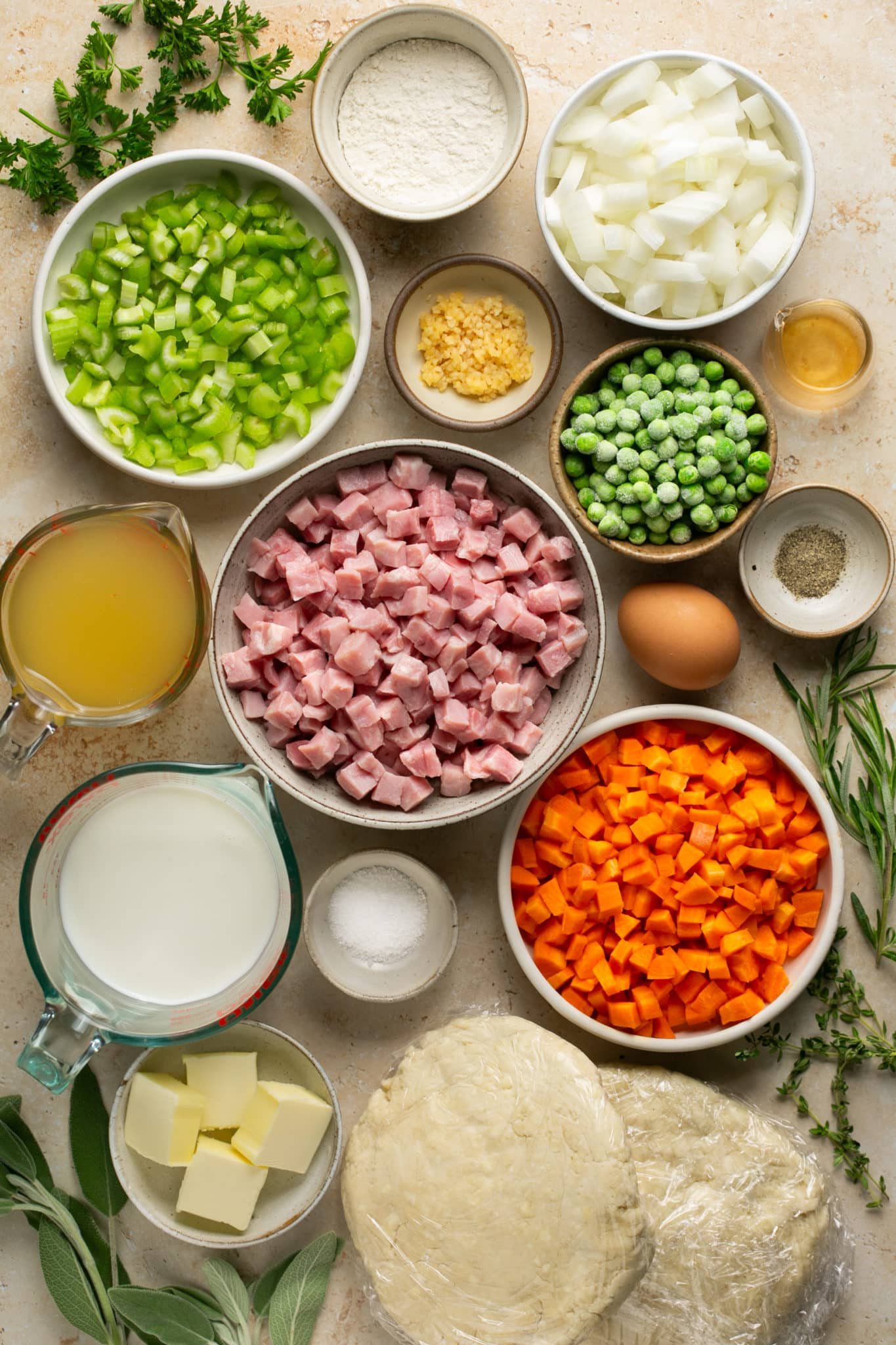 ingredients in small glass dishes needed to make a pot pie. 