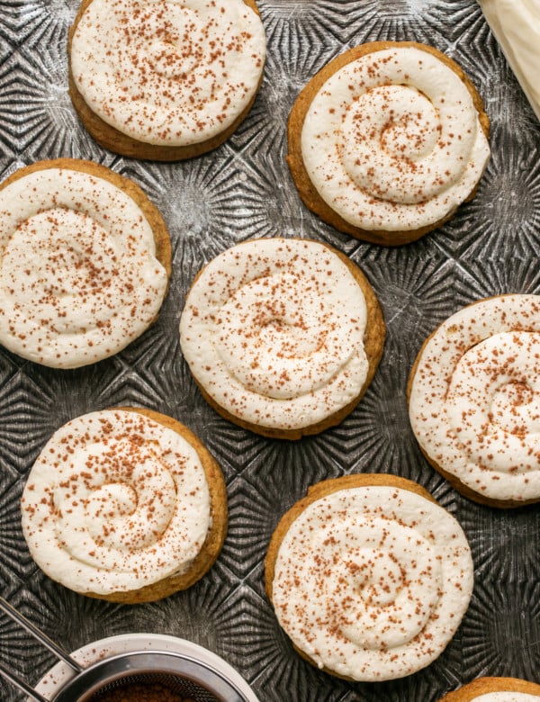 multiple frosted tiramisu cookies sprinkled with cinnamon