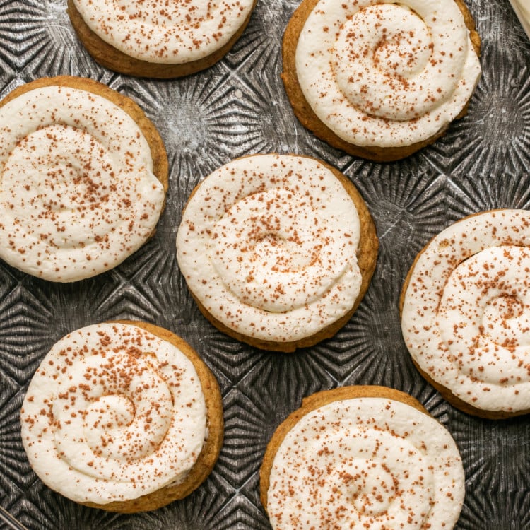 multiple frosted tiramisu cookies sprinkled with cinnamon