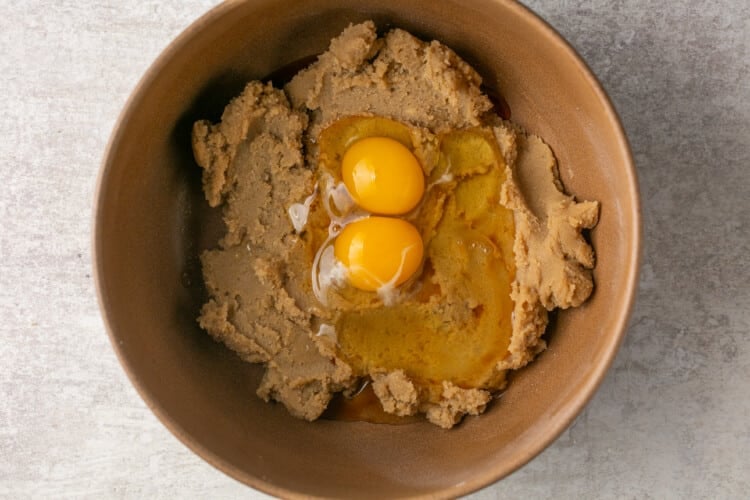 eggs added to cookie dough in a bowl