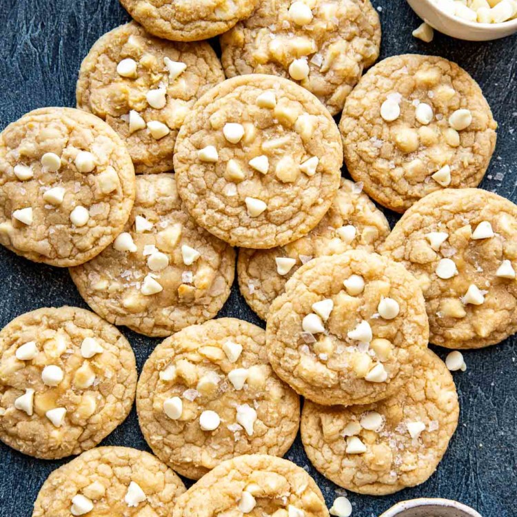 cookies with macadamia nuts and white chocolate chips laying on top of one another