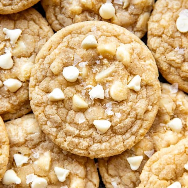 close up of cookies with white chocolate chips and macadamia nuts