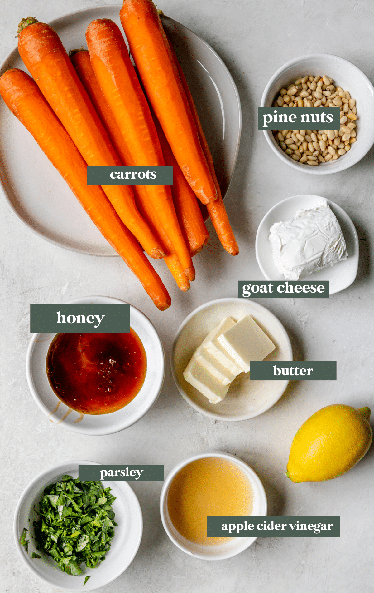 ingredients to make carrots with honey in small white glass dishes.