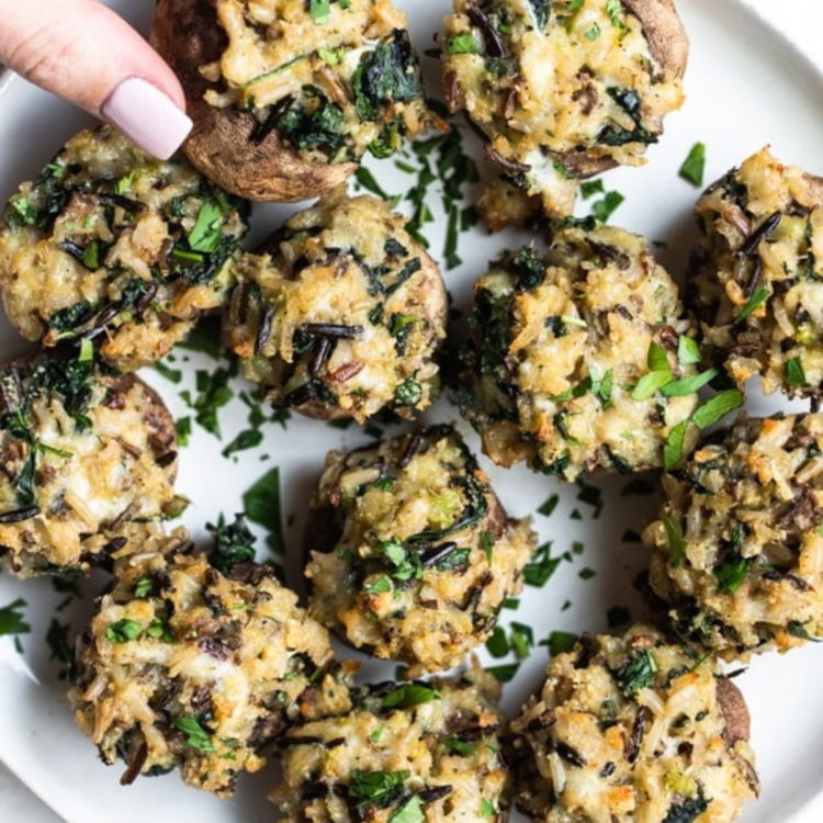 mushrooms stuffed with rice and herbs on a white plate