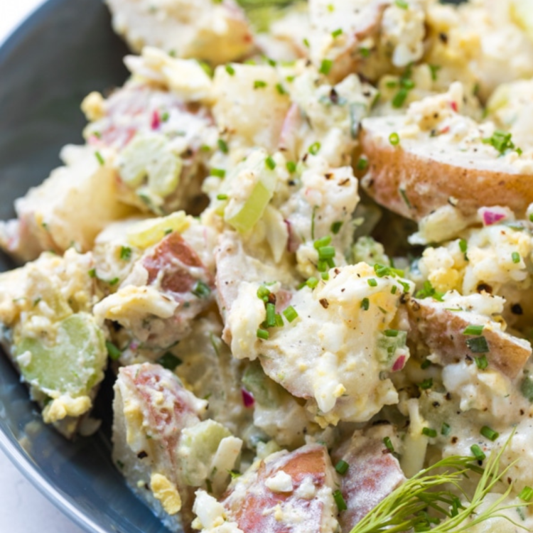 bowl of potato salad with herbs