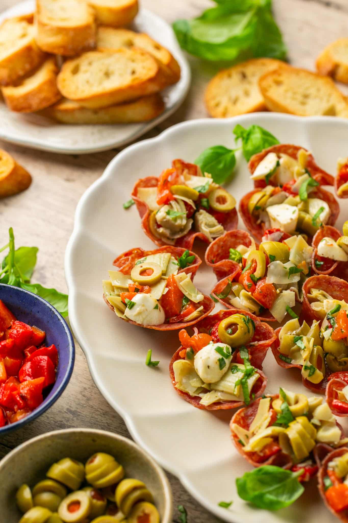 antipasto cups on a white serving platter. 