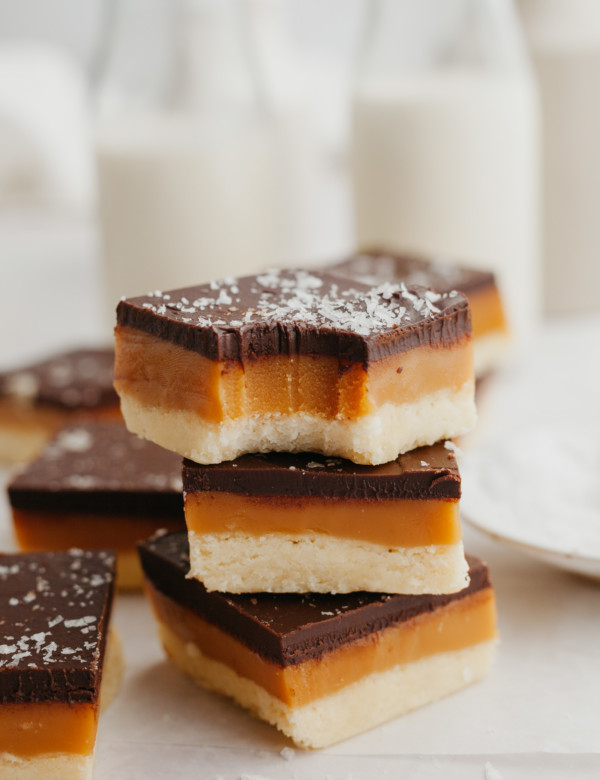 shortbread cookie bars stacked with a bite taken out of the top one