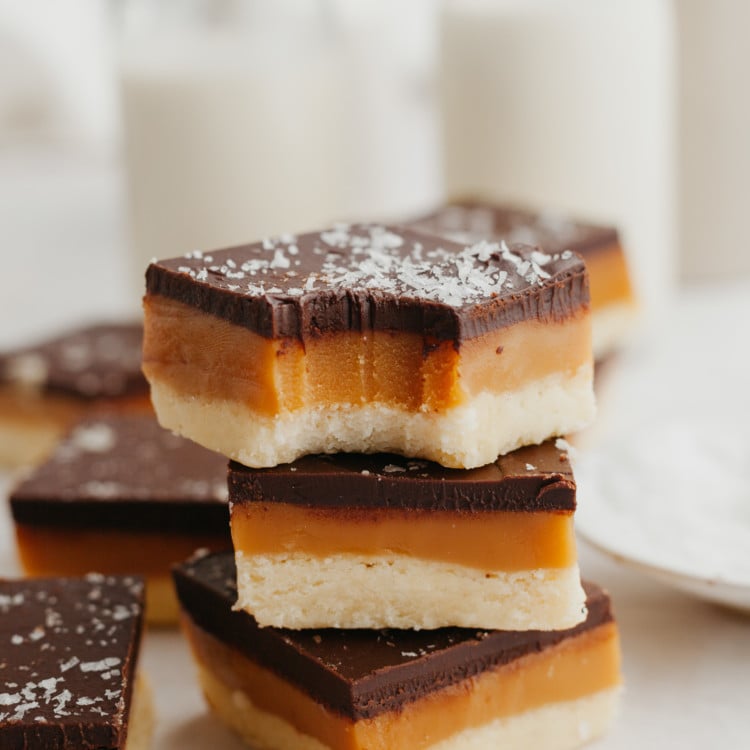 shortbread cookie bars stacked with a bite taken out of the top one