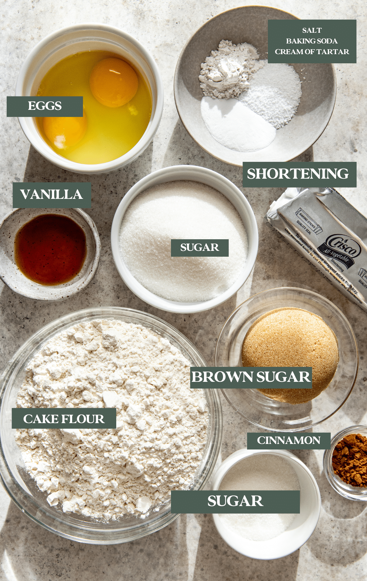 Ingredients to make cookies in small glass bowls. 